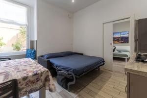 a small bedroom with a bed and a window at Moon Bologna in Bologna