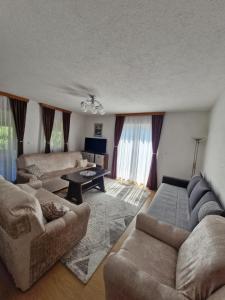 a living room with a couch and a table at Unique Una in Ripač
