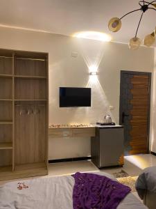 a bedroom with a desk and a tv on the wall at 3pyramids view inn in Cairo