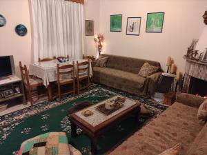 a living room with a couch and a table at Family PlayHouse - Villa Mitsi Sarande in Sarandë