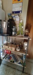 a shelf with a coffee maker and other items on it at Agroturystyka Magnolia in Cieszyno +51 photos