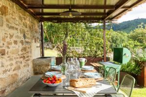 a table with plates of food on a patio at Relais Tosca in Cortona