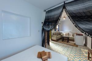 a room with a bed and a living room at Hotel Nisrine in Chefchaouen
