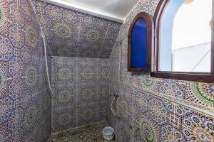 a bathroom with a shower and a window at Hotel Nisrine in Chefchaouen +85 photos
