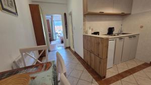 a kitchen with a sink and a counter top at Luna di mare 2 Igalo in Igalo