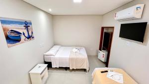 a hospital room with a bed and a tv at Pousada Angellus in Paraty