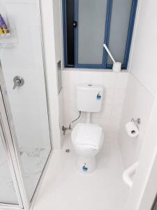 a white bathroom with a toilet and a shower at Hobart city hotel in Hobart +12 photos