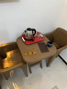 a small table with a tea kettle on top of it at 3pyramids view inn in Cairo