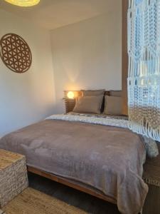 a bedroom with a bed with a light on the wall at Agapanthe location in San-Nicolao +36 photos