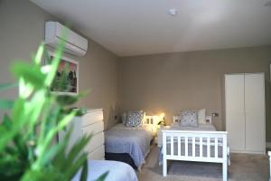 a bedroom with two beds and a white crib at Ambassador House in Carrick on Shannon