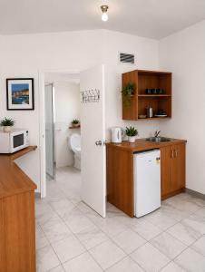a kitchen with a sink and a microwave at Hobart city hotel in Hobart