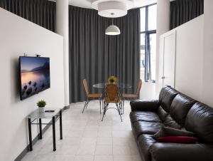 a living room with a couch and a table at Hobart city hotel in Hobart