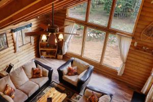 an overhead view of a living room in a log cabin at Rustic Mountain Log Cabin with Fire Pit in Duck Creek Village +16 photos