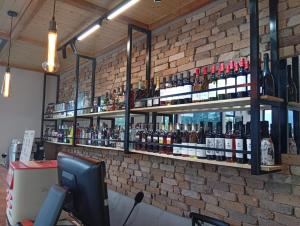 a brick wall with shelves of wine bottles at Lake side Dilijan in Dilijan