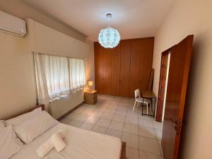 a bedroom with a bed and a chandelier at Theodorou Town Residence in Strovolos