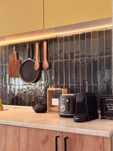 a kitchen with a counter with a microwave and utensils at Bragorski Apartment in Makedonski Brod