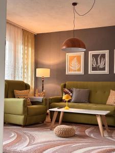 a living room with a couch and a table at Bragorski Apartment in Makedonski Brod