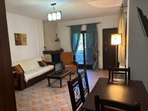 a living room with a couch and a table at Menir Apartments in Prinos