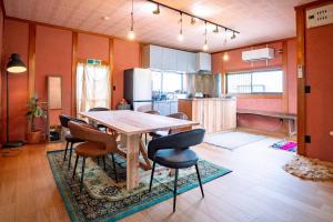 a kitchen and dining room with a table and chairs at 錆と煤 sabitosusu INN-prema- in Aki