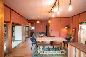 a living room with a table and chairs at 錆と煤 sabitosusu INN-prema- in Aki +45 photos