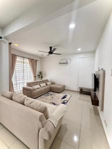 a living room with a couch and a tv at Singgah homestay saujana aster in Putrajaya