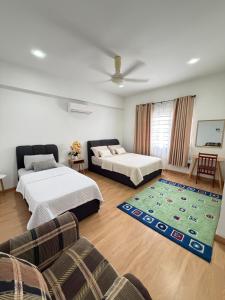 a living room with two beds and a couch at Singgah homestay saujana aster in Putrajaya +11 photos
