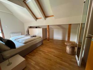 a bedroom with a bed and a wooden floor at U Izhu with Private Pool, Sauna & BBQ in Prevala +53 photos