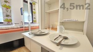 a kitchen with two white plates on a counter at Aparthotel Marion Weber in Bremen +195 photos