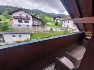 a balcony with a view of a house at Alpen Appartements in Embach