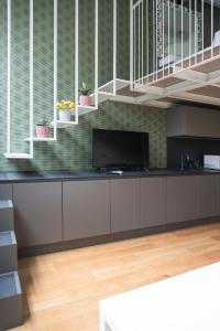 a kitchen with a counter with a tv on it at Youhosty - Lambro12 in Milan +15 photos