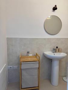 a bathroom with a sink and a mirror at Marechiaro apartment in Monopoli