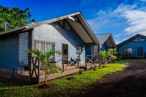 a blue and white house with a porch at Cabañas Henua Iti in Hanga Roa