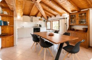 a kitchen and dining room with a wooden table and chairs at Villa Adele in Gravedona