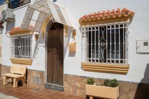 a white building with a window and a bench at Casa Alcazaba in Guadix