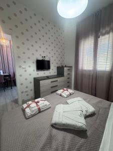a bedroom with a bed with two towels on it at Casa Paloma Free Parking in Bolsena