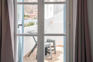 a view from a window of a table and chair at Narkissos Hotel in Kamari