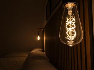 a chandelier with lights hanging from a wall at Zurria Rooms in Catania +23 photos