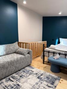 a living room with a couch and a bed at Apartments Gabliani in Mestia in Mestia