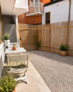 a patio with a bench and a fence at Appartamenti Bellaria Vacanza e Relax in Bellaria-Igea Marina