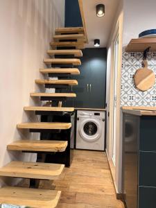 a staircase in a kitchen with a washing machine at Apartments Gabliani in Mestia in Mestia