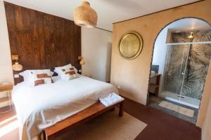 a bedroom with a large bed and a mirror at Ferme du ru paisible in Tournières