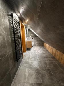 a hallway of a bathroom with a sink and a toilet at Agroturystyka Pod Podkową in Darłowo +30 photos