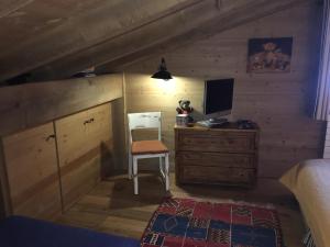 a bedroom with a bed and a desk with a computer at Chalet Mine de rien in Megève +6 photos