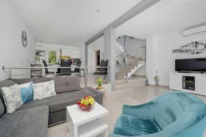 a living room with a couch and a table at House Green in Vrh
