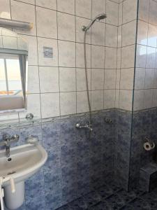 a bathroom with a shower and a sink at Хотел Черно море in Sveti Vlas