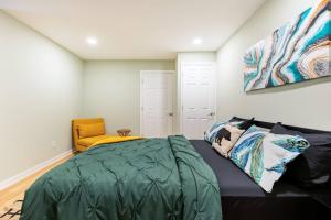 a bedroom with a bed and a yellow chair at Shenandoah Thunder Chalet Guest Suite in Front Royal