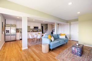a living room with a blue couch and a kitchen at Shenandoah Thunder Chalet Guest Suite in Front Royal