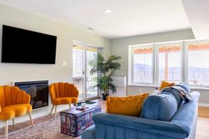 a living room with a blue couch and orange chairs at Shenandoah Thunder Chalet Guest Suite in Front Royal