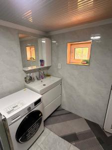 a small kitchen with a stove and a sink at Yurt guesthouse in Osh