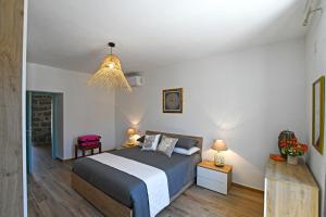 a bedroom with a bed and a pendant light at Stazzo Rosalba in Arzachena